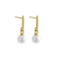 Gold earrings with white pearls on a gray background