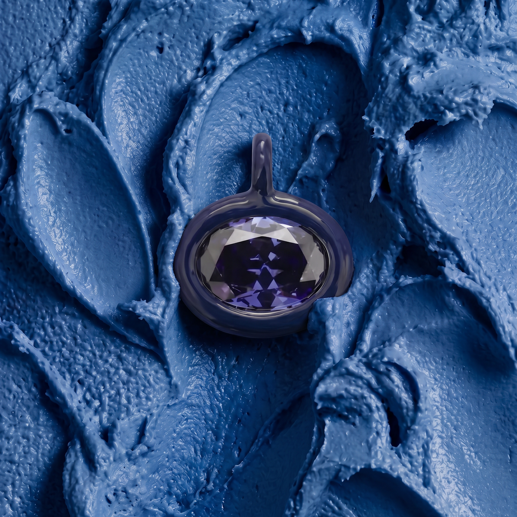 A faceted oval gemstone pendant with a dark metallic bezel, set against a textured, sculpted blue background.